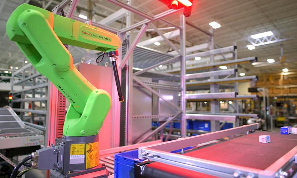 An assembly line with a robot arm in an Nvidia factory.