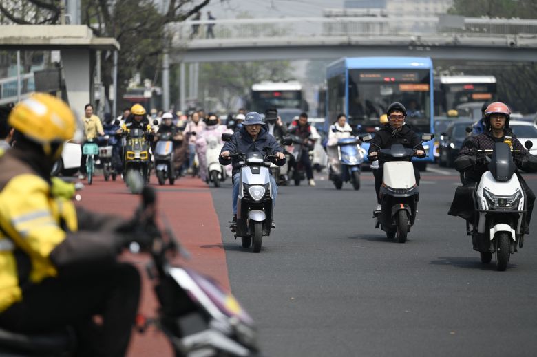 People riding electric scooters in Beijing traffic last month.