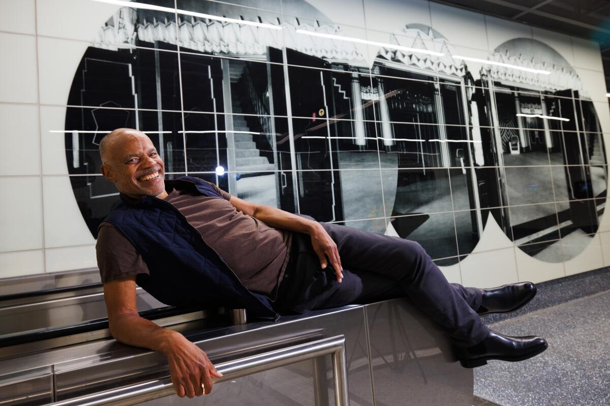  Artist Todd Gray lies down in front of his work inside the Wilshire/La Cienega Metro Station