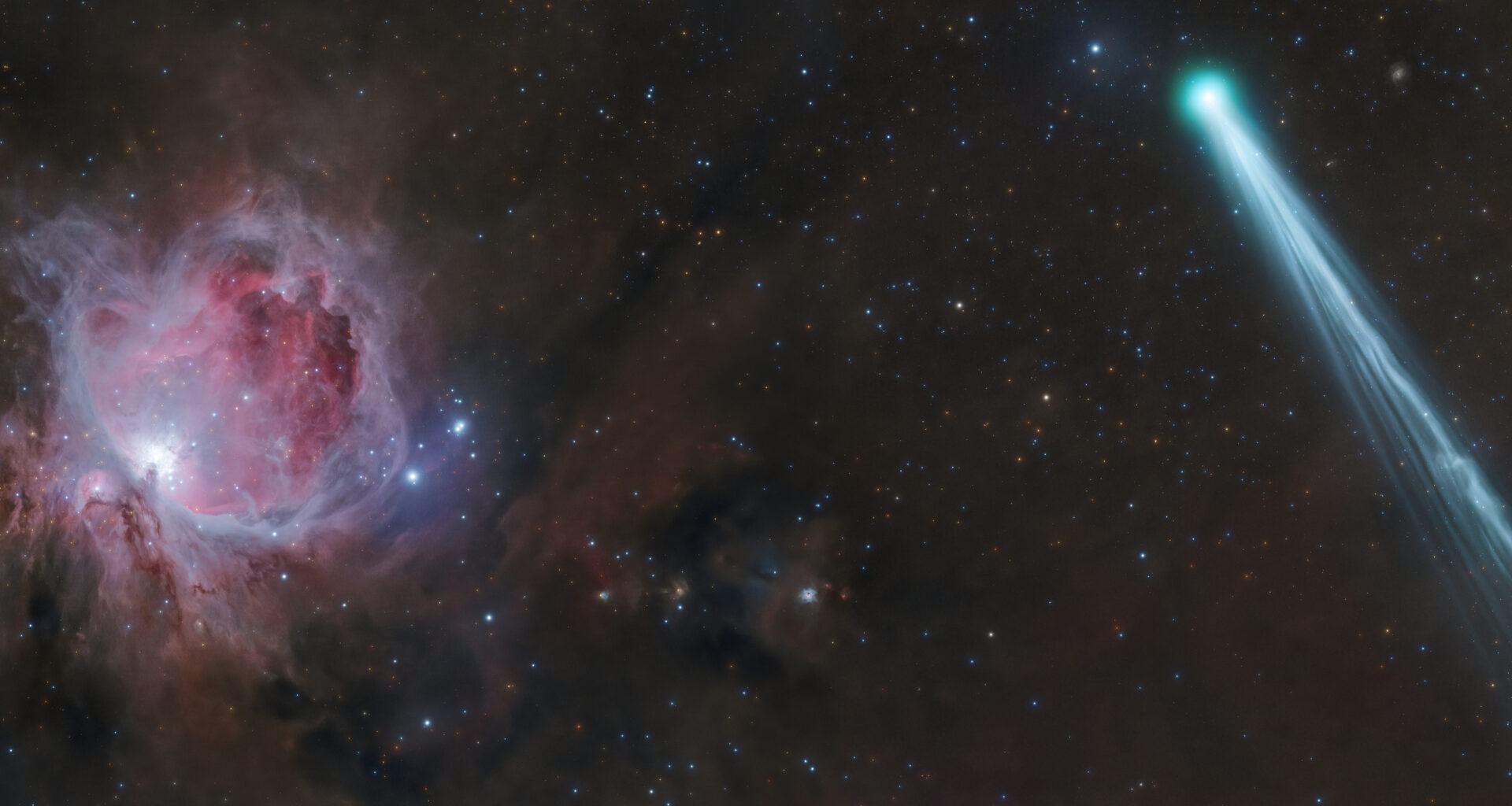 The bright blue Comet R3 PanSTARRS streaks across the right side of the image with the red cloud of the Orion Nebula in the background on the left.