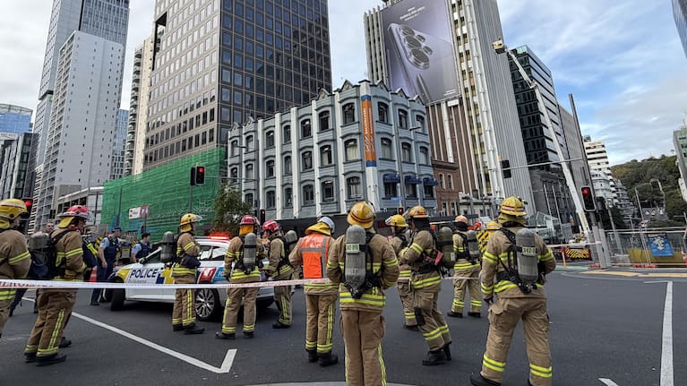 Firefighters and police at the scene of a fire at a hotel in the Auckland CBD.