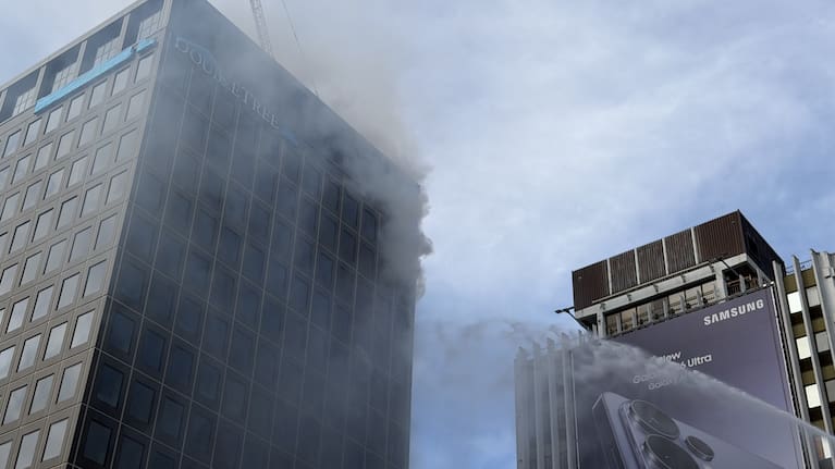 A hose attacks a blaze at a hotel in the Auckland CBD.