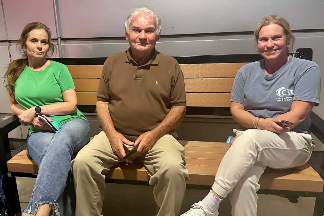Tonya Miles (right) sits with family outside ECU Health Medical Center in Greenville, North Carolina. Miles said they had “only been here six hours” after bringing her mother to the emergency room for a potential blood clot in her leg.