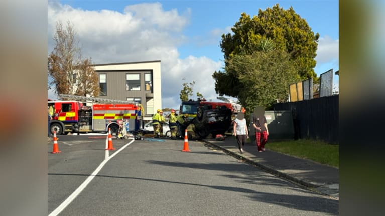 Firefighters at the scene of a collision between a car and motorcycle in Howick, Auckland.