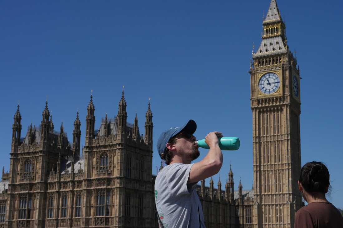 A man drinks Tuesday outside the Palace of Westminster in London.