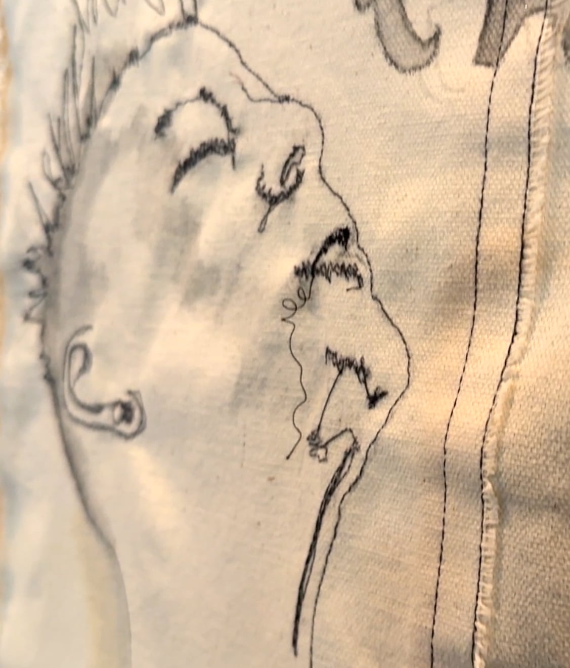A stitched face of a woman with closed eyes looking toward the sky