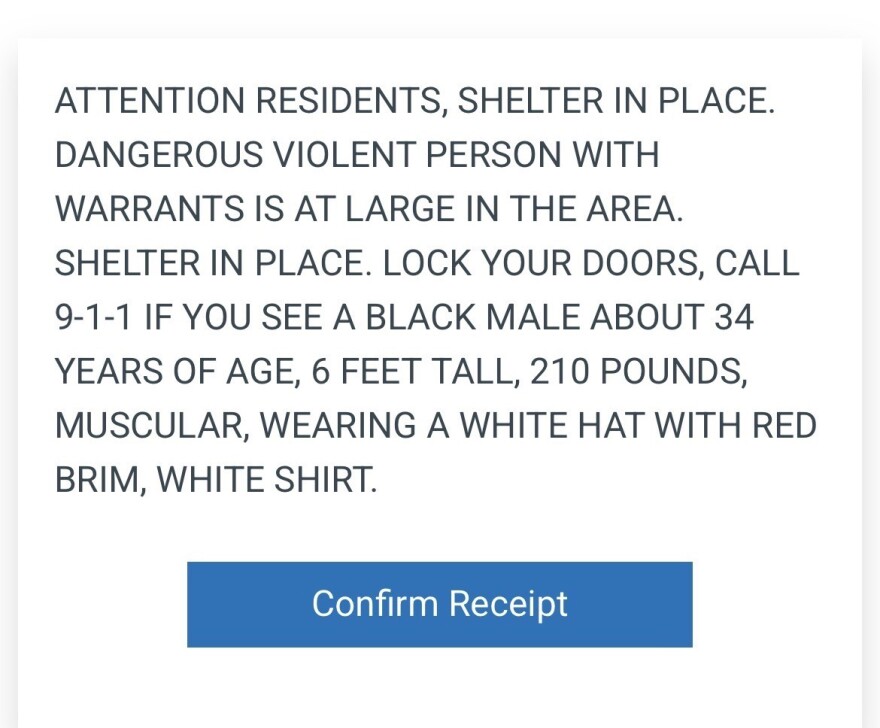 A screenshot of an alert message that reads "ATTENTION RESIDENTS, SHELTER IN PLACE.
DANGEROUS VIOLENT PERSON WITH WARRANTS IS AT LARGE IN THE AREA.
SHELTER IN PLACE. LOCK YOUR DOORS, CALL 9-1-1 IF YOU SEE A BLACK MALE ABOUT 34 YEARS OF AGE, 6 FEET TALL, 210 POUNDS, MUSCULAR, WEARING A WHITE HAT WITH RED BRIM, WHITE SHIRT."