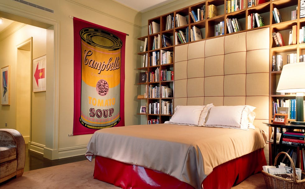 Bedroom featuring a Campbell's soup banner and a bookshelf.
