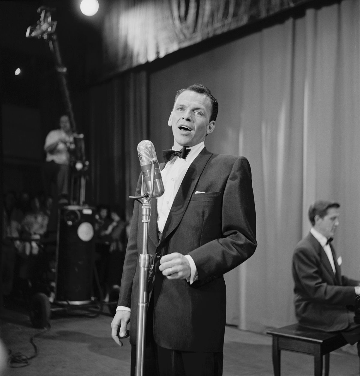 American singer and actor Frank Sinatra, wearing a tuxedo and bow tie, performs during the United Cerebral Palsy telethon, at the studios of KECA-TV in Los Angeles, California, 16th June 1952