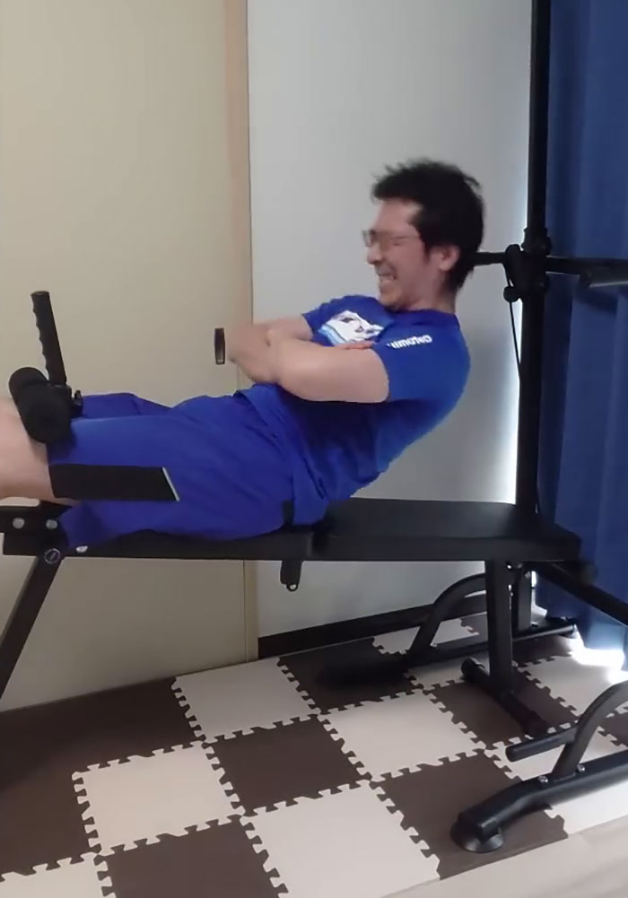 Japanese YouTuber doing sit-ups on a workout bench in Saitama routine Japanese YouTuber doing sit-ups on a workout bench in Saitama routine