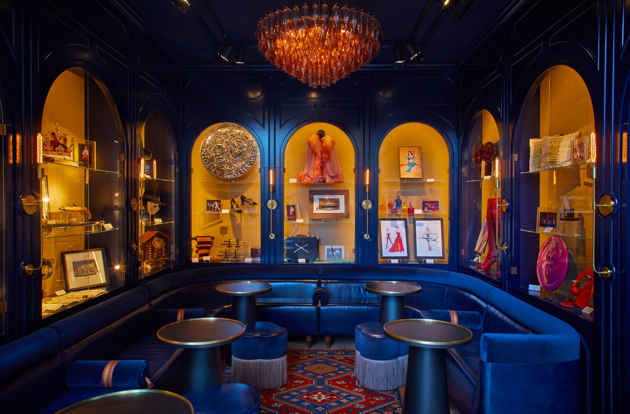 stylish lounge area with display shelves showcasing various theater memorabilia