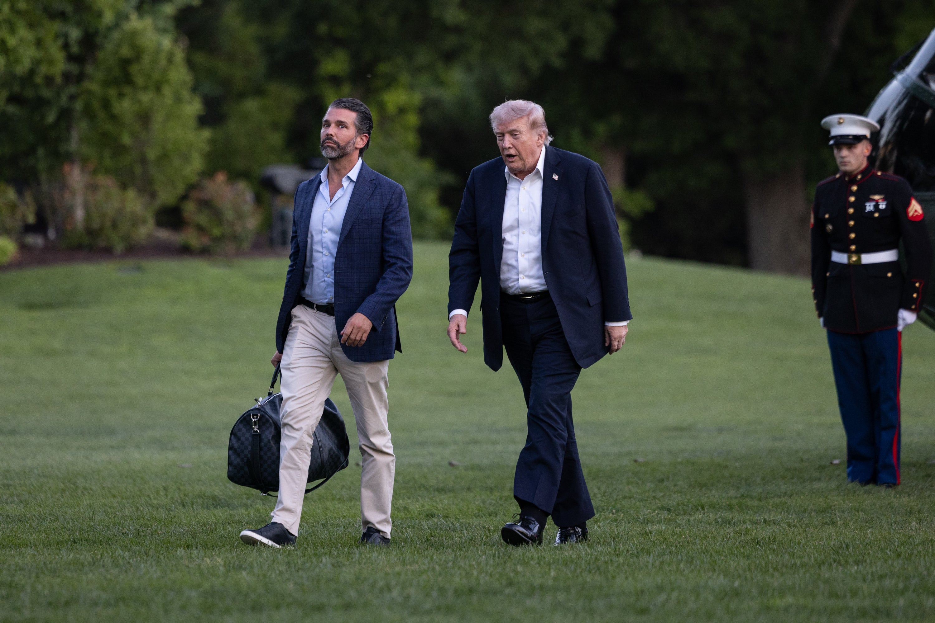 President Donald Trump and his son, Donald Trump Jr, walking across the South Lawn of the White House. Trump visited a dentist in Florida over the weekend, and upon his return was spotted suffering from swollen ankles