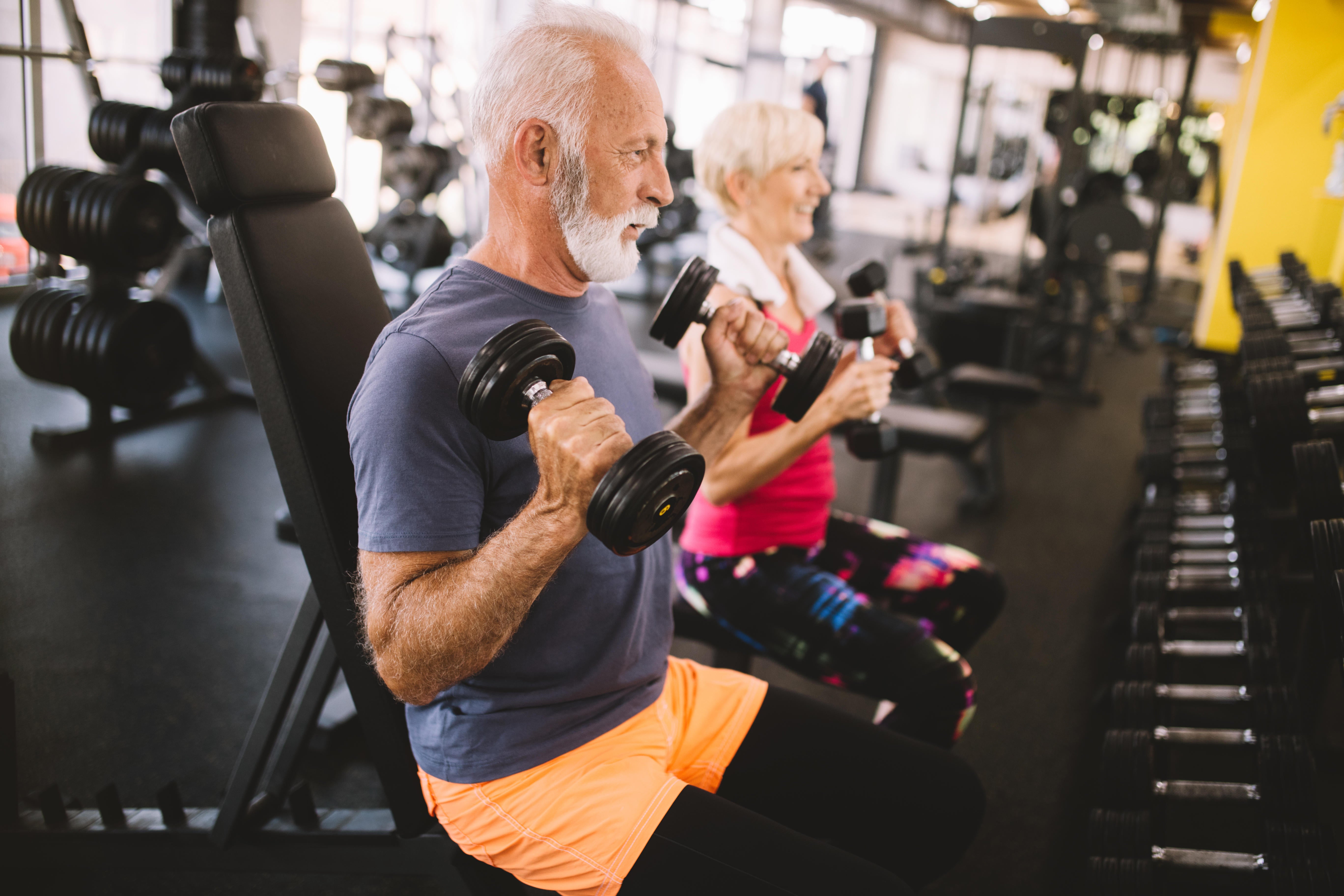 A man and a woman exercising in the gym