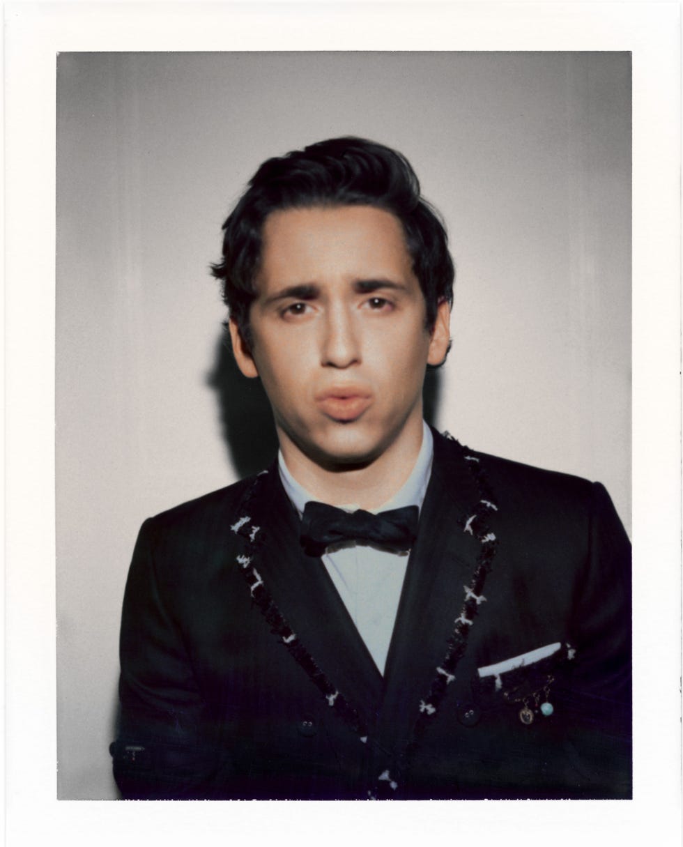 Portrait of an individual in a tuxedo with a bow tie.