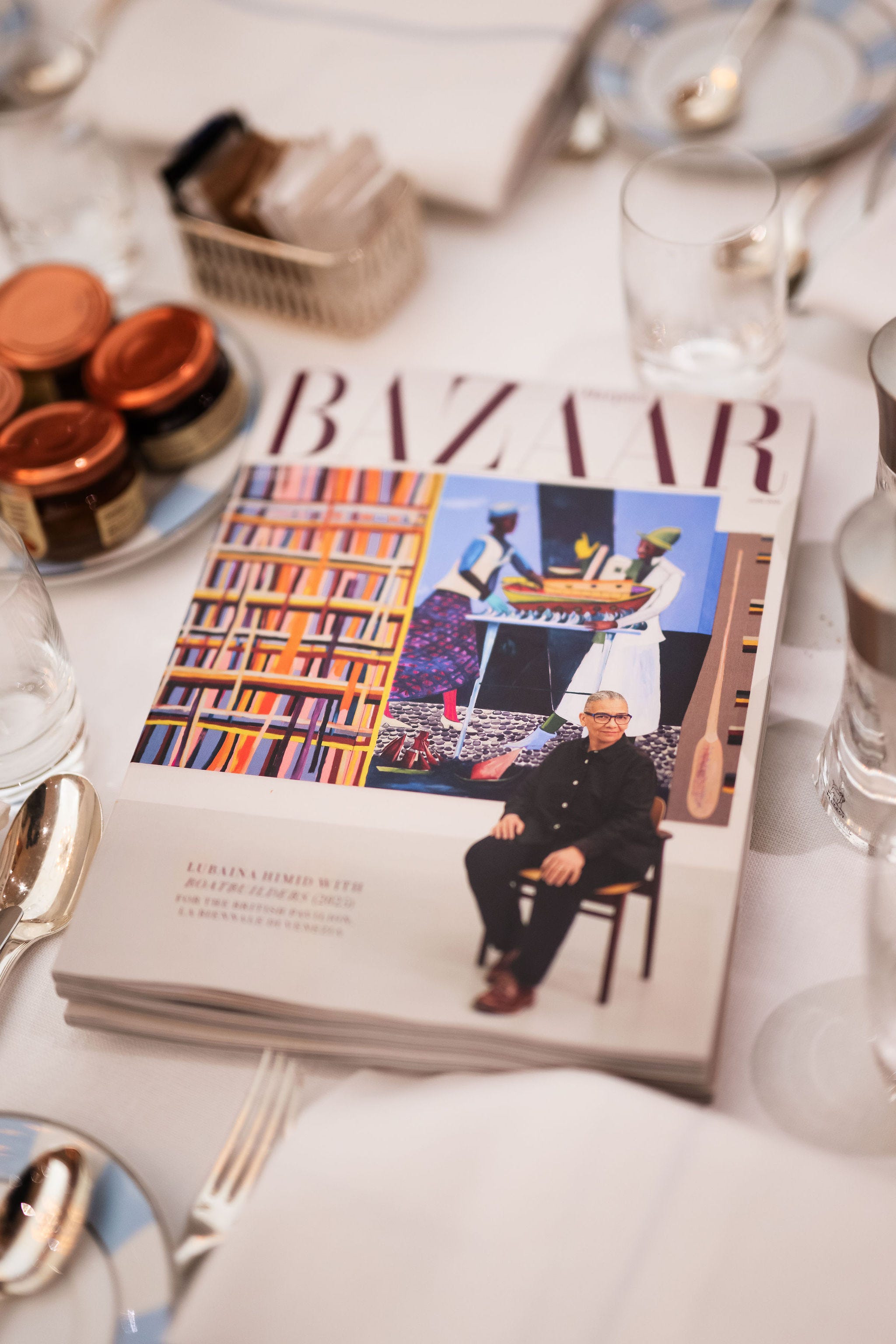 Fashion magazine displayed on a table with condiments Fashion magazine displayed on a table with condiments