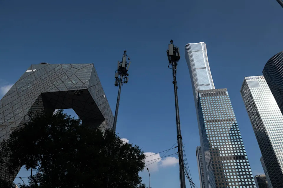 <span>Two 5G towers are pictured in Beijing in 2020</span><div><span>NICOLAS ASFOURI</span><span>AFP</span></div>