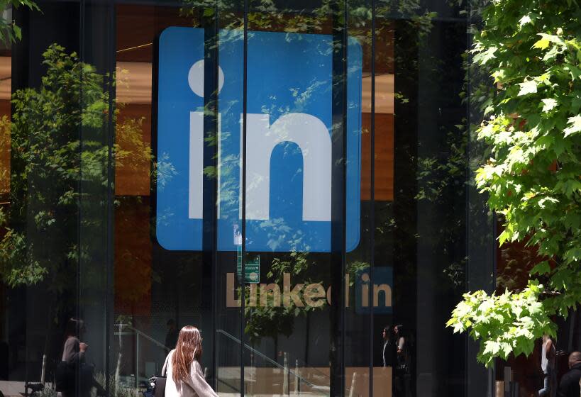 SAN FRANCISCO, CALIFORNIA - JULY 26: A pedestrian walks by a sign at a LinkedIn office on July 26, 2023 in San Francisco, California. LinkedIn announced plans to cut nearly 200 jobs at offices in the San Francisco Bay Area. The cuts follow 700 layoffs earlier in the year. (Photo by Justin Sullivan/Getty Images)