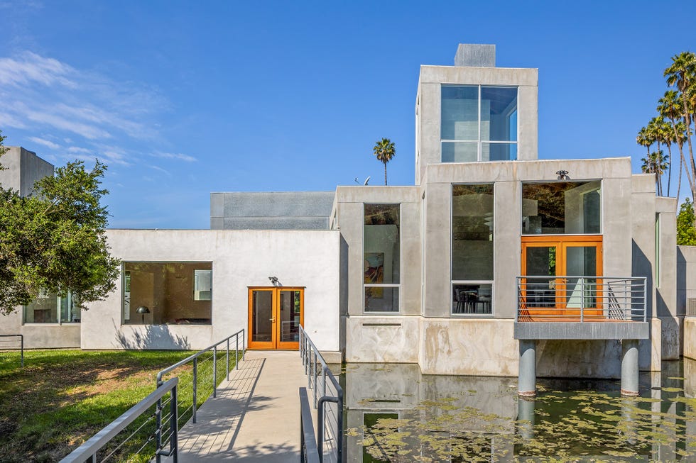 Modern architectural structure with a bridge and water feature.