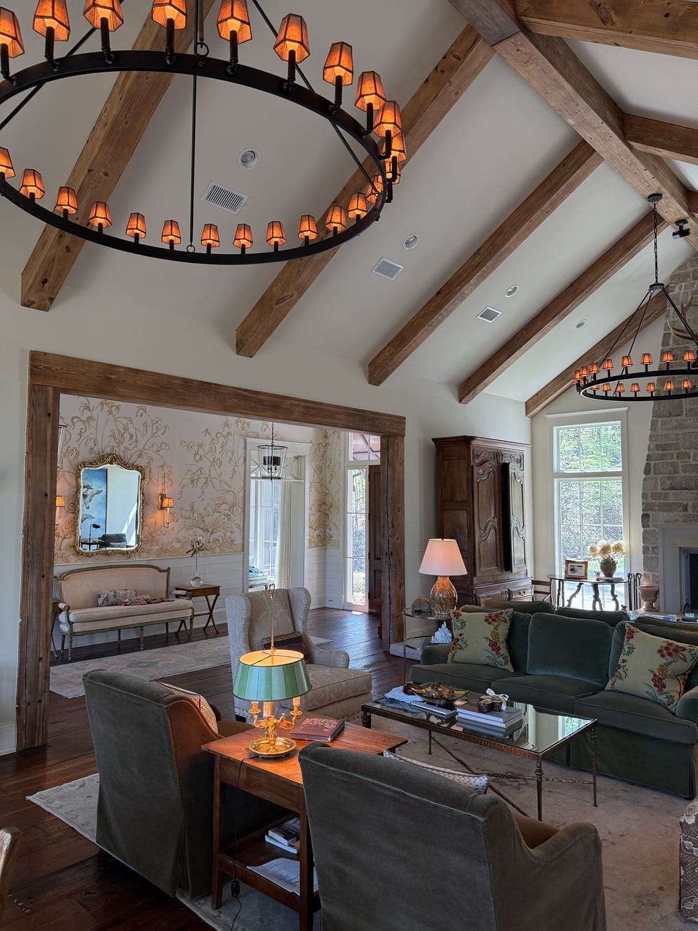 Living room featuring a rustic design with wooden beams and stylish furniture.