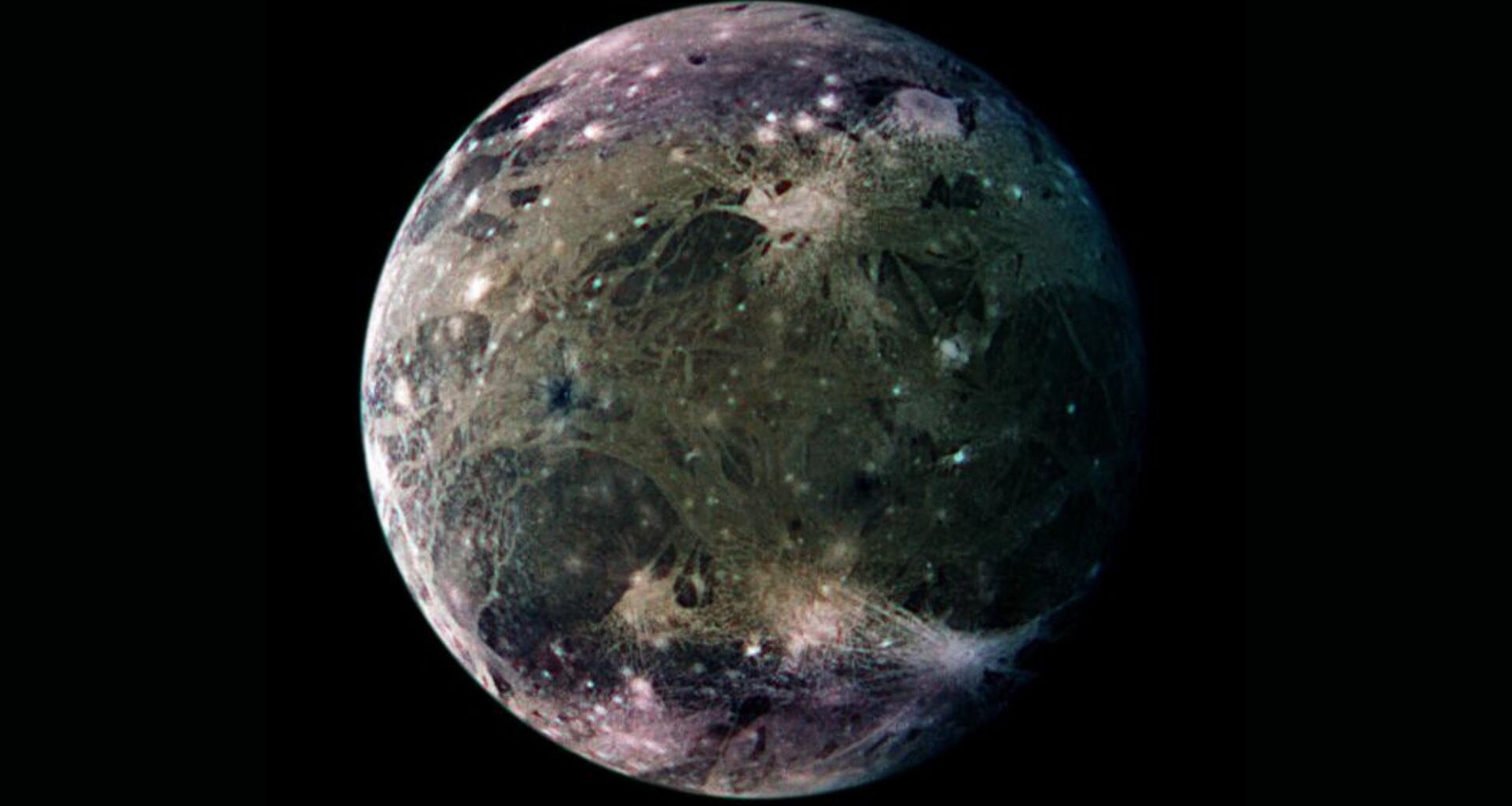 A close up of the blue and gray moon Ganymede in the darkness of space.