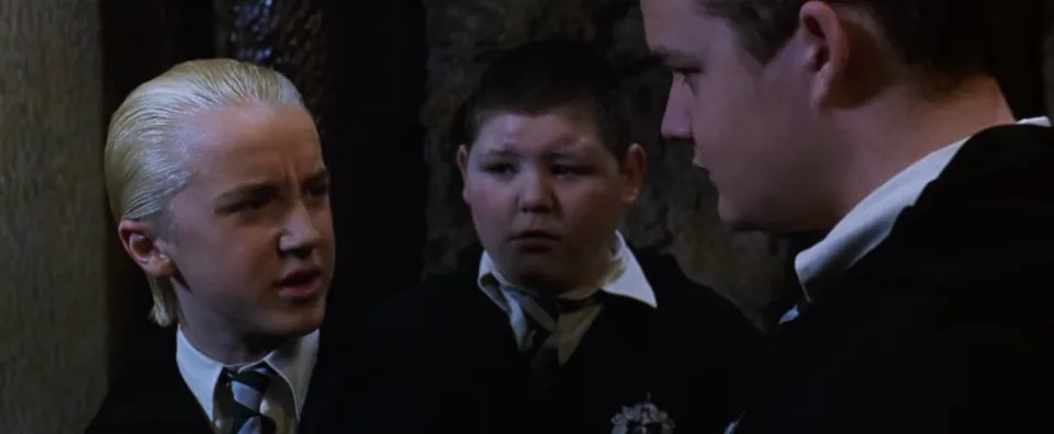 Tom Felton talking to two other guys in "Harry Potter and the Chamber of Secrets"