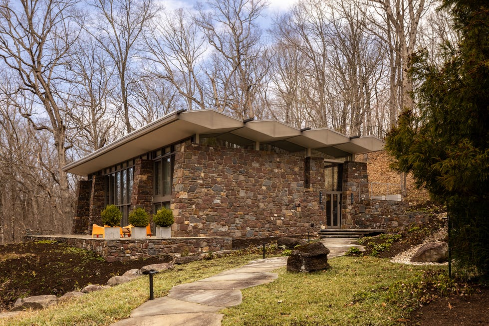 Modern stone house surrounded by trees