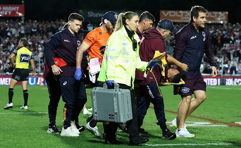 Siosiua Taukeiaho being taken from the field.