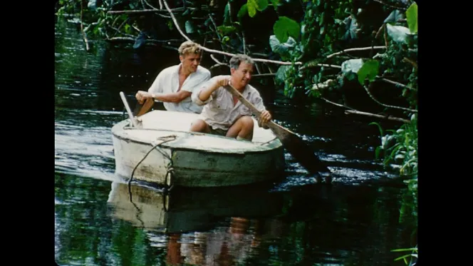 David Attenborough and Jack Lester in a rowboat, searching for the hoatzin bird in Guiana.