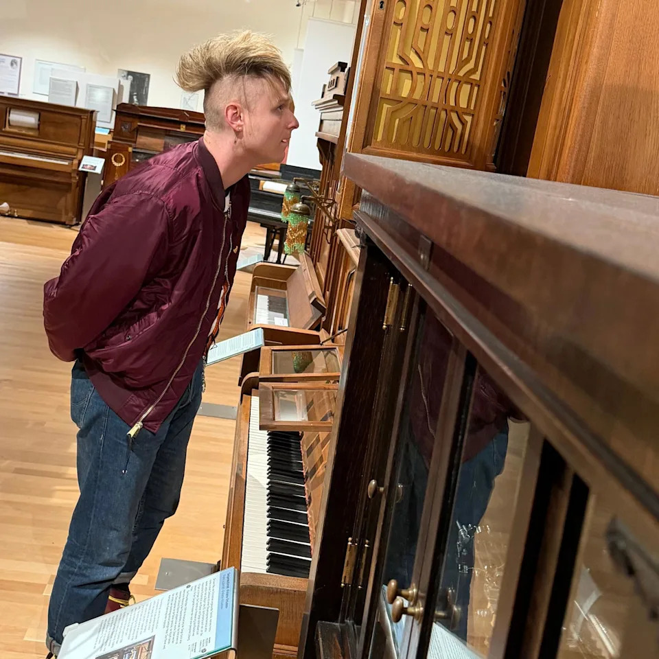 Sam Battle stares at a mechanical piano inside Vienna's Museum of Science and Technology