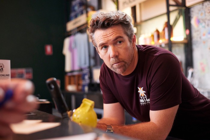 484608,Colin From Accounts S2 Patrick Brammall as Gordon in Colin From Accounts, leaning over a bar