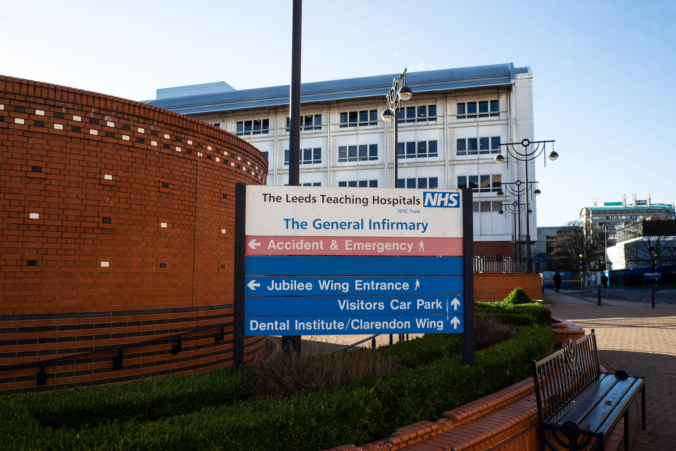 Sign outside the Leeds General Infirmary teaching hospital with directions to Accident & Emergency, Jubilee Wing Entrance, Visitors Car Park, and Dental Institute/Clarendon Wing.
