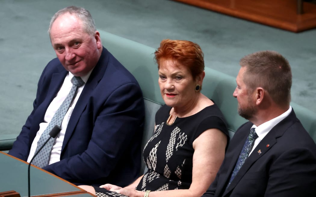 Australia’s One Nation Senator Pauline Hanson (C) and Member of the Parliament Barnaby Joyce (L) attend a joint sitting of the House of Representatives during an address by European Commission President Ursula von der Leyen in Canberra on March 24, 2026. (Photo by David GRAY / AFP)