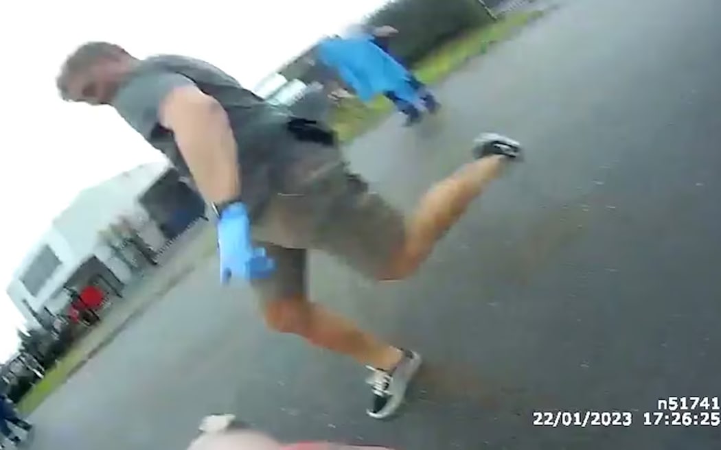 An officer kicks Jodi Knott, in body-worn camera vision her family has fought to have released. (Supplied)