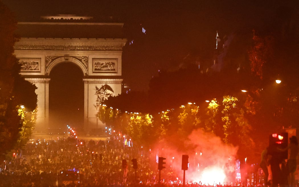 PSG supporters gather on the Champs-Elysees Avenue after the club won the UEFA Champions League final between Paris Saint-Germain (PSG) and Arsenal FC played in Budapest, in Paris on May 30, 2026. (Photo by ROMEO BOETZLE / AFP) / ALTERNATE CROP