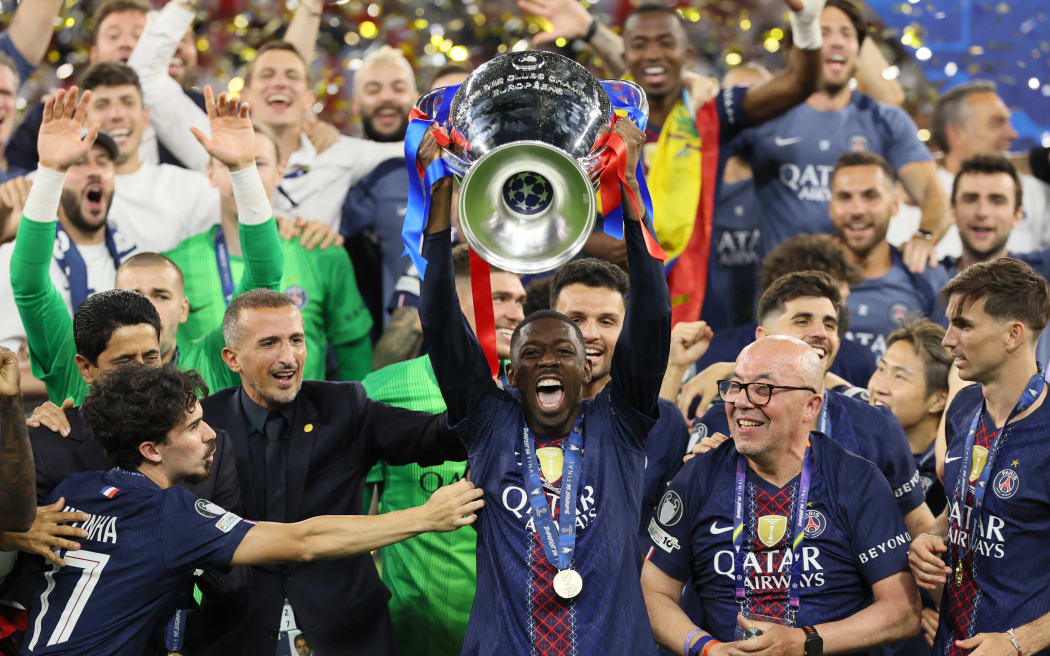 Paris Saint-Germain's French forward #10 Ousmane Dembele lifts the trophy after winning the UEFA Champions League final football match between Paris Saint-Germain (PSG) and Arsenal FC at the Puskas Arena in Budapest on May 30, 2026. (Photo by Odd ANDERSEN / AFP)