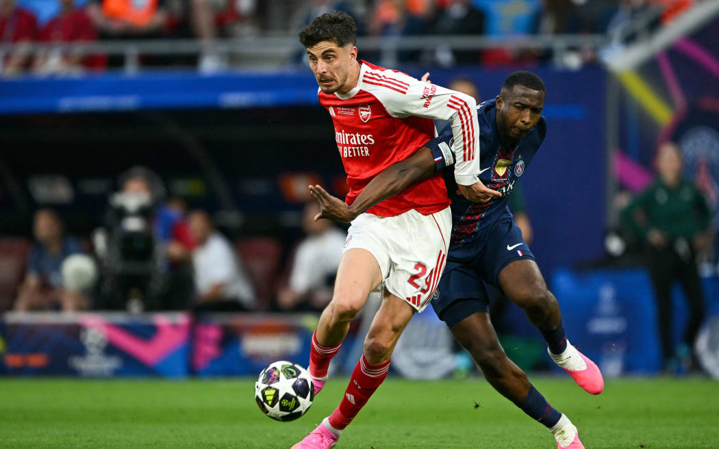 Arsenal's German forward #29 Kai Havertz (L) and Paris Saint-Germain's Ecuadorian defender #51 Willian Pacho vie for the ball during the UEFA Champions League final football match between Paris Saint-Germain (PSG) and Arsenal FC at the Puskas Arena in Budapest on May 30, 2026. (Photo by NICOLAS TUCAT / AFP)