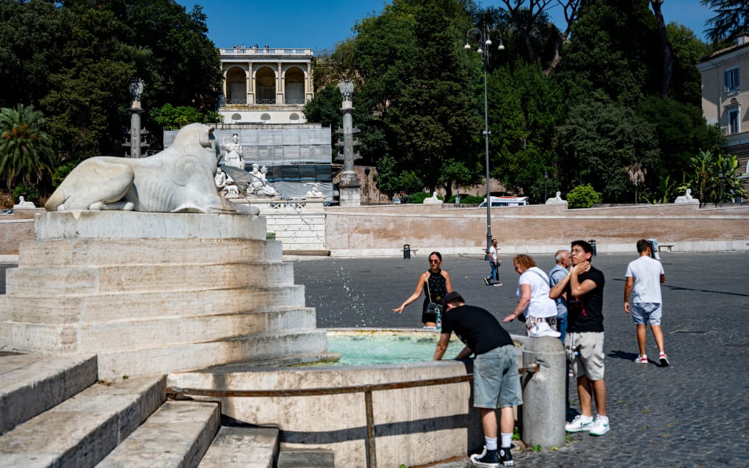 People cool off during an ongoing heat wave with temperatures reaching 40 degrees at Piazza del Popolo in Rome, Italy, on July 6, 2025.