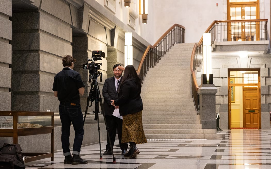 New Zealand Herald Wellington business editor Jenée Tibshraeny records a few budget 2026 thoughts from economist Brad Olson in the Press Gallery kitchen. With lots of extra bodies on precinct for Budget Day, people grab space where they can.