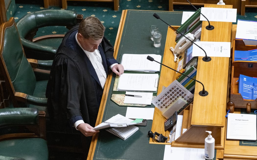 Clerk Assistant James Picker, at the Table in Parliament’s debating chamber, checks a ruling to advise the Speaker.