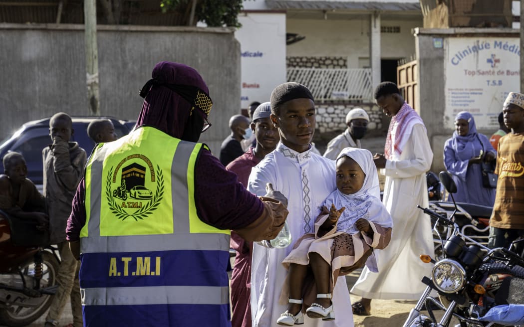 A worshipper has his temperature taken outide a Mosque in Bunia, in the eastern Democratic Republic of the Congo, on May 27, 2026 the first day of Eid al-Adha, the Feast of Sacrifice. (Photo by Glody MURHABAZI / AFP)