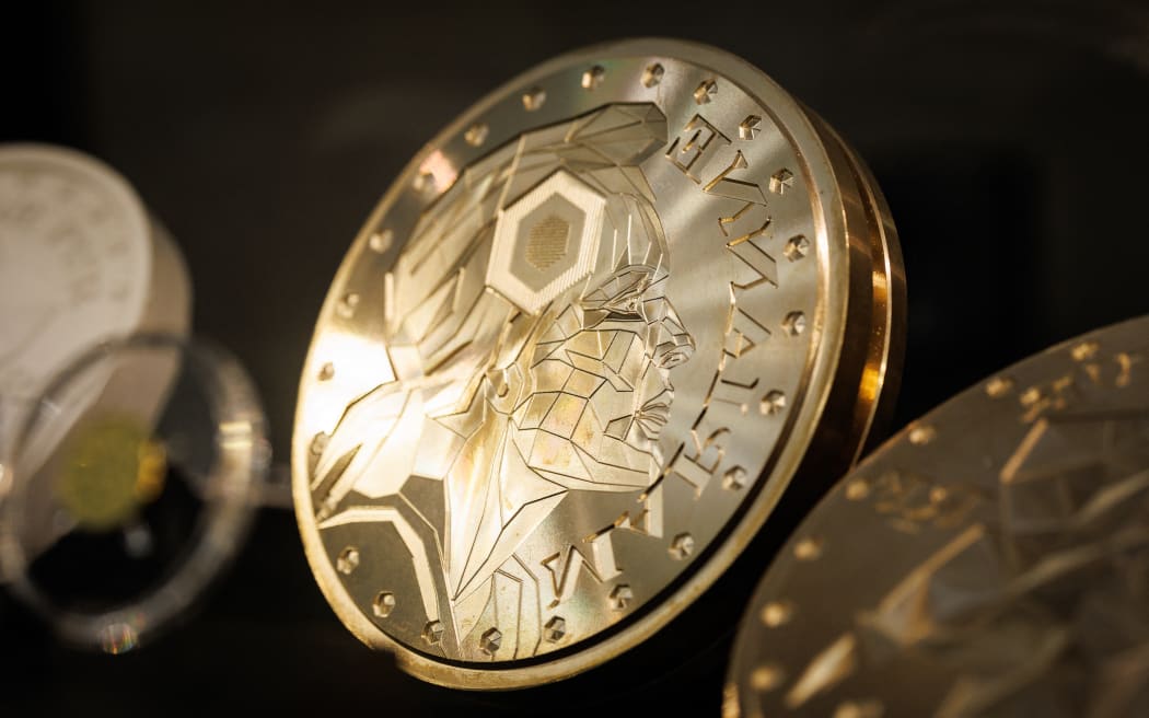 This photograph shows a Marianne-Or gold coin bullion pattern used in the process displayed at La Monnaie de Paris in Paris on May 21, 2026. The Paris Mint said on May 26, 2026, that it would soon start selling solid-gold coins for investment, the first since it quit making Napoleons and Louis a century ago. Four versions of the new Marianne coins will go on sale June 16, ranging from one-tenth of an ounce (3.1 grams) to a full ounce (31.1 grams). (Photo by SIMON WOHLFAHRT / AFP)