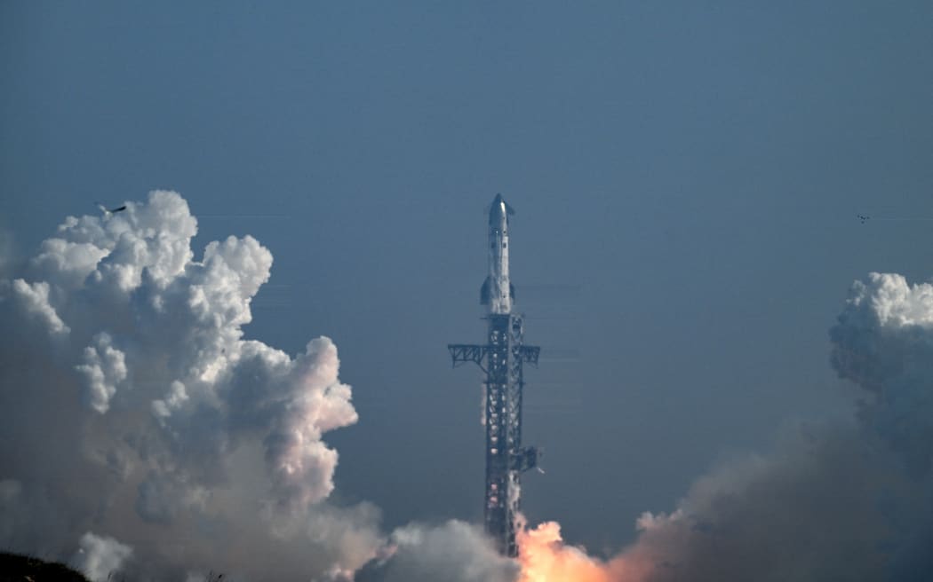 SpaceX's Starship 39 rocket launches from Starbase during the 12th test flight as seen from South Padre Island, Texas, on May 22, 2026. Elon Musk's SpaceX on May 22 launched its latest Starship, sending the mammoth rocket soaring into the Texas skies after its initial attempt was scrubbed due to technical issues. The Starship spacecraft and Super Heavy rocket booster appeared to separate as expected, but the company's spokesperson Dan Huot said on the livestream that the booster did not complete a burn necessary to steer itself to a controlled landing, meaning it likely can't make a precision touchdown as hoped. (Photo by RONALDO SCHEMIDT / AFP)