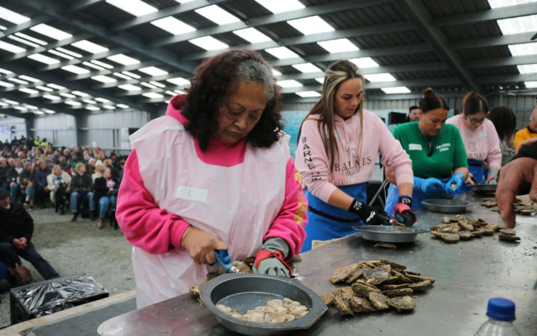 Herepaenga Witehira (left) and Tia Selwyn speed-shucking oysters.