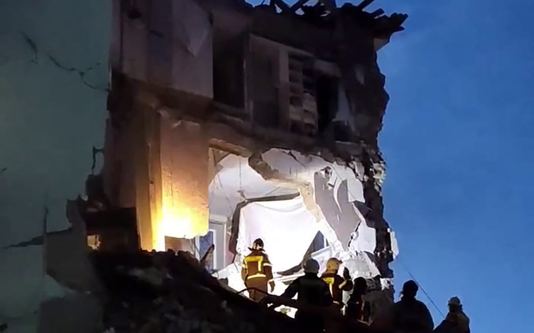 In this grab from a handout footage released by the Russian Ministry of Emergency Situations on April 22, 2026, rescuers work at the scene of a heavily damaged apartment building following a drone attack in Syzran.