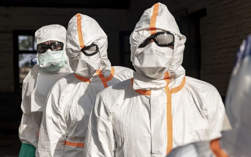 MONGBWALU, DEMOCRATIC REPUBLIC OF CONGO - MAY 20: Workers line up to disinfect their protective equipment at General Referral Hospital of Mongbwalu during the Ebola outbreak response in Mongbwalu, Ituri province, eastern Democratic Republic of Congo, on May 20, 2026. The World Health Organization (WHO) has declared the Ebola outbreak in the Democratic Republic of Congo (DRC) and Uganda a "public health emergency of international concern," as the death toll and number of confirmed cases continue to rise. The current epidemic is caused by the Bundibugyo virus, one of several Orthoebolaviruses that can cause Ebola disease, and for which there are no approved vaccines. The highest number of cases have been reported in Congo's eastern Ituri province, bordering Uganda. Global health officials have expressed grave concern over the capacity to contain the outbreak in a region already facing a humanitarian crisis, with highly mobile populations displaced by conflict and economic factors. (Photo by Michel...