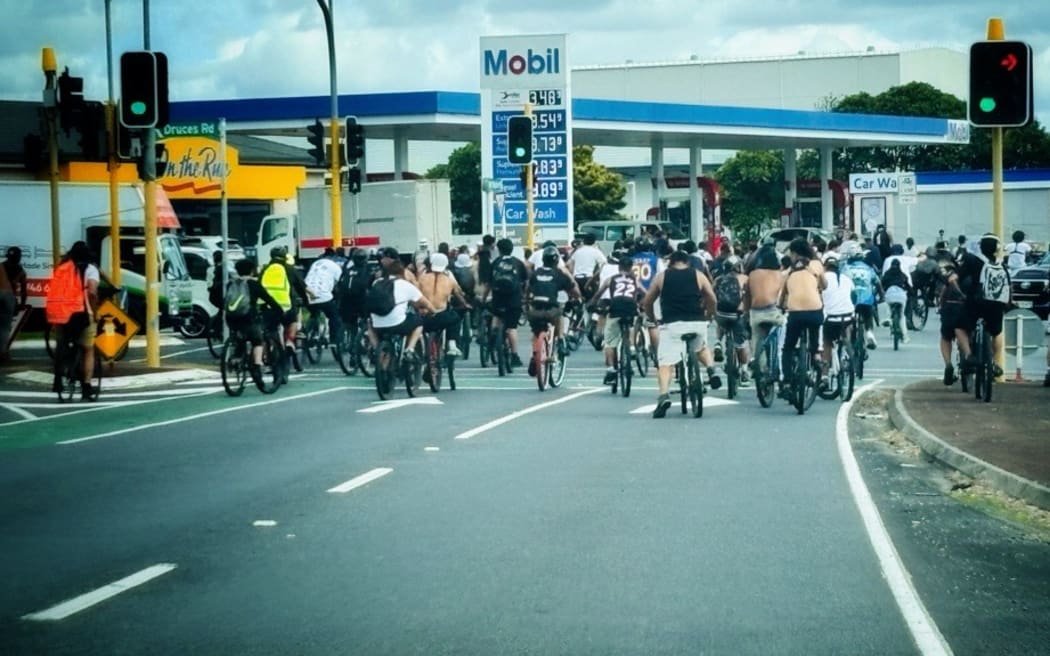 A large group of cyclists taking up the road in Manukau.