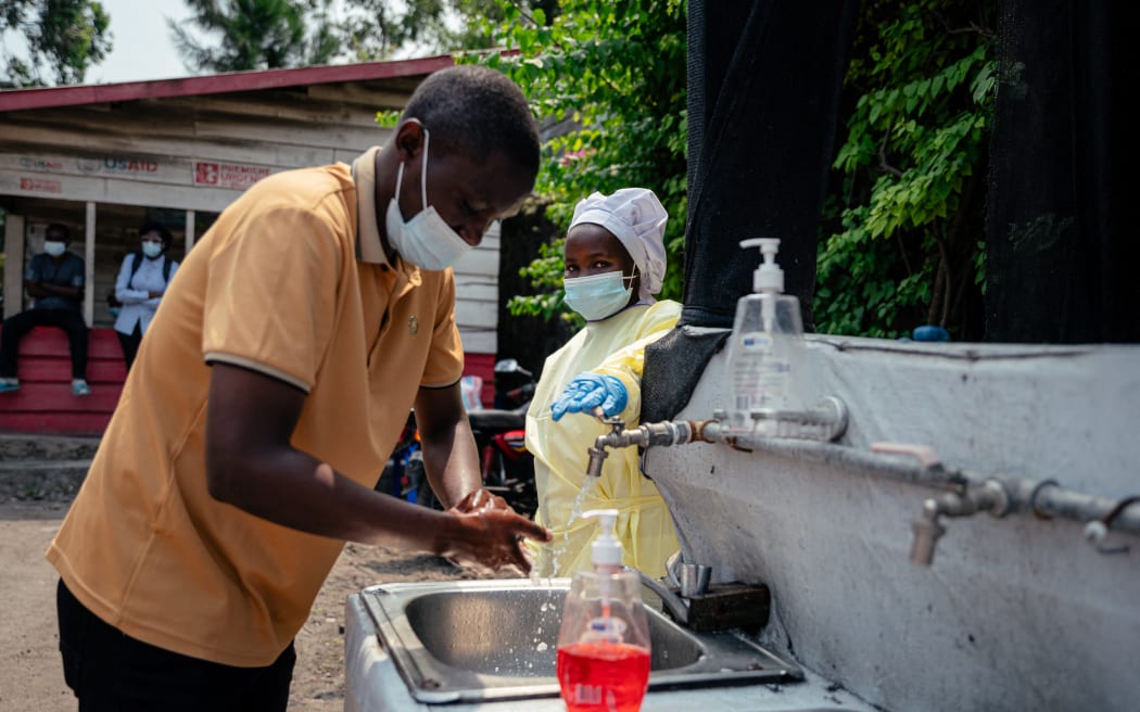 A visitor washes his hands before entering Kyeshero Hospital at a checkpoint for hand washing and temperature screening for all visitors and patients entering Kyeshero Hospital, as part of Ebola prevention measures in Goma on May 18, 2026. A first case of Ebola virus infection has been reported in Goma, a major city in eastern Democratic Republic of Congo controlled by the M23 armed group, with the WHO declaring an international health alert on May 17, 2026.