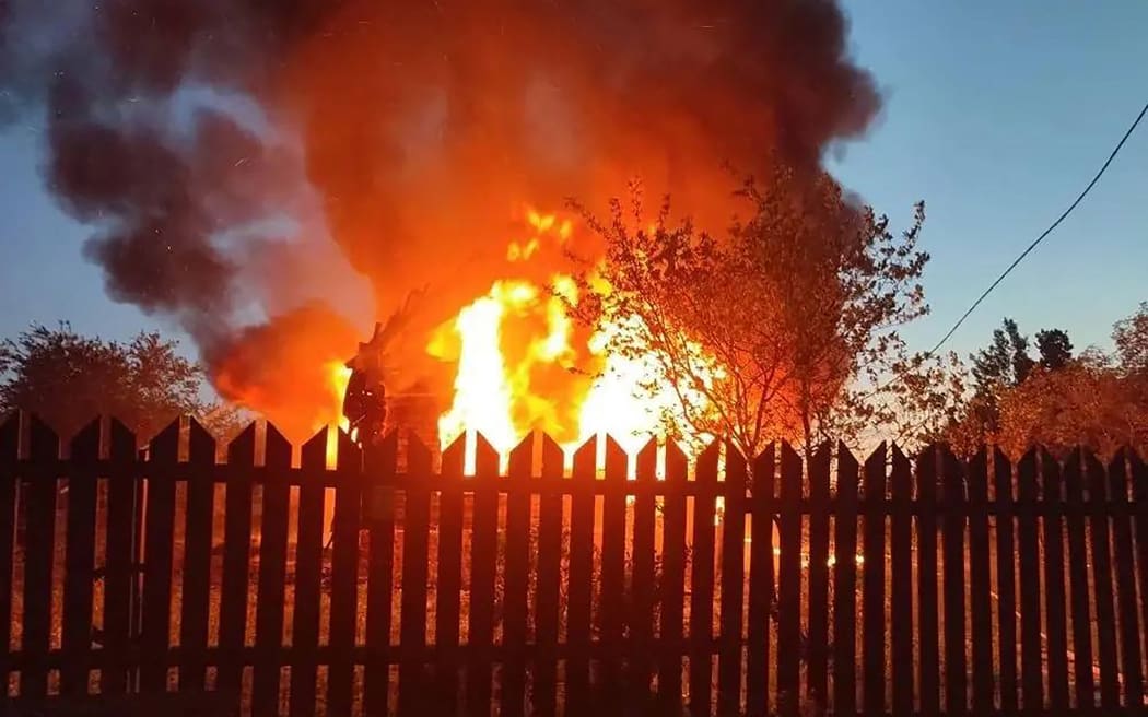 This handout photograph posted on the official Telegram channel of Moscow Region Governor Andrey Vorobyov on May 17, 2026 shows a burning building following an air attack at an undisclosed location in the Moscow region, amid the ongoing Russian-Ukrainian conflict. A huge wave of more than 500 Ukrainian drones attacked Russia overnight, killing three people in the Moscow region, authorities said on May, 17, 2026. Air defences shot down 556 drones in more than a dozen regions, including Moscow, Russia's defence ministry said, in one of the largest Ukrainian barrages of the ongoing conflict so far. (Photo by Handout / TELEGRAM / @vorobiev_live / AFP) / RESTRICTED TO EDITORIAL USE - MANDATORY CREDIT "AFP PHOTO / TELEGRAM / @vorobiev_live / handout"" - HANDOUT - NO MARKETING NO ADVERTISING CAMPAIGNS - DISTRIBUTED AS A SERVICE TO CLIENTS