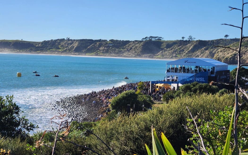 Hundreds of spectators crowded the shoreline of Manu Bay, Raglan, to watch the New Zealand Surfing Championships on 17 May 2026.