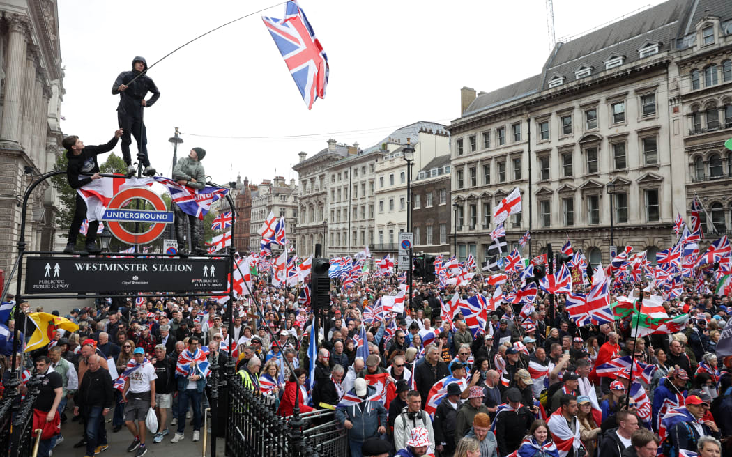 On Whitehall, supporters of British far-right activist Tommy Robinson, real name Stephen Yaxley-Lennon, take part in a march organised by Unite The Kingdom, in central London on May 16, 2026. (Photo by Toby Shepheard / AFP)